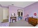 Bedroom showcasing a vanity, dresser, walk-in closet, and purple painted walls at 5325 Bradbury Ct, Tampa, FL 33624