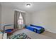 bedroom with a car bed, a play trampoline, carpet floors, and a large window at 5325 Bradbury Ct, Tampa, FL 33624