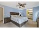 Spacious bedroom with a large bed, nightstand, carpet flooring, and ensuite bathroom at 5325 Bradbury Ct, Tampa, FL 33624