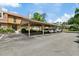 View of a multi-car carport with reserved parking spots in front of the building at 5325 Bradbury Ct, Tampa, FL 33624