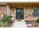 Charming front entry with stone facade, decorative door, and manicured landscaping at 5325 Bradbury Ct, Tampa, FL 33624