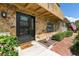 Charming home entrance with a stone facade, black door, brick walkway and manicured shrubs at 5325 Bradbury Ct, Tampa, FL 33624