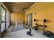 Enclosed patio featuring gym equipment, table, ceiling fan, and screened-in porch at 5325 Bradbury Ct, Tampa, FL 33624