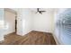 Bright bedroom with ceiling fan and wood-look floors at 3455 Countryside Blvd # 52, Clearwater, FL 33761