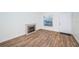 Bright living room with fireplace and wood-look floors at 3455 Countryside Blvd # 52, Clearwater, FL 33761