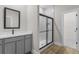 Bathroom featuring a shower with glass doors, gray vanity, and tile floor at 5321 Crestline Ter, Port Charlotte, FL 33981