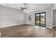 Bright living room with wood-look floors and a sliding glass door to the backyard at 5321 Crestline Ter, Port Charlotte, FL 33981