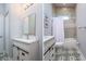 Charming bathroom features a patterned tile floor, vanity with storage and shower-tub combo at 3604 W Paxton Ave, Tampa, FL 33611