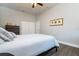 A bedroom features a bed, dresser, closet, ceiling fan and a large window at 3604 W Paxton Ave, Tampa, FL 33611