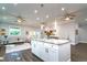 Open living room area with a kitchen island in the background featuring hardwood floors and recessed lighting at 3604 W Paxton Ave, Tampa, FL 33611