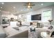 Open living room area with view into the kitchen featuring hardwood floors, recessed lights, and modern furniture at 3604 W Paxton Ave, Tampa, FL 33611