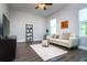 This light and airy living room features dark hardwood floors and a modern ceiling fan at 3604 W Paxton Ave, Tampa, FL 33611