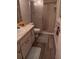 Bathroom featuring a shower, toilet, sink, and wood-look tile flooring at 5143 Vassar Ln, Sarasota, FL 34243