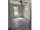 Bedroom with wood-look tile flooring, a ceiling fan, and a window at 5143 Vassar Ln, Sarasota, FL 34243