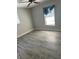 Bedroom with natural light, ceiling fan, and wood-look flooring at 5143 Vassar Ln, Sarasota, FL 34243