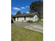 Home exterior showing the lawn, siding, and a partially visible car at 5143 Vassar Ln, Sarasota, FL 34243