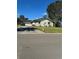 View of a single-story home showcasing the driveway and surrounding yard at 5143 Vassar Ln, Sarasota, FL 34243