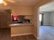 Kitchen with bar, white cabinetry, and a view to the living area at 5143 Vassar Ln, Sarasota, FL 34243