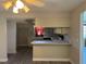 Kitchen with bar, white cabinetry, and a view to the living area at 5143 Vassar Ln, Sarasota, FL 34243