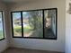 An interior view through a large window shows the front yard and a glimpse of the neighborhood across the street at 5143 Vassar Ln, Sarasota, FL 34243