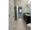 Bathroom with double vanity and access to bedroom at 8219 Caponata Blvd, Seminole, FL 33777