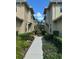 Neat walkway between two townhouses with lush landscaping at 8219 Caponata Blvd, Seminole, FL 33777