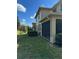 Townhouse exterior with screened patio and landscaped yard at 8219 Caponata Blvd, Seminole, FL 33777