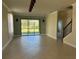 Spacious living room featuring tile floors and access to backyard at 8219 Caponata Blvd, Seminole, FL 33777