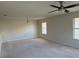 Bright and airy living room featuring neutral walls and carpet at 8219 Caponata Blvd, Seminole, FL 33777