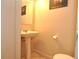 Small bathroom with pedestal sink and toilet at 117 114Th N Ave # 117, St Petersburg, FL 33716