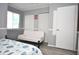 Bedroom with white built-in closet and sofa at 117 114Th N Ave # 117, St Petersburg, FL 33716