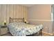 Cozy bedroom with wood-like wall accents and a seashell patterned bedspread at 117 114Th N Ave # 117, St Petersburg, FL 33716