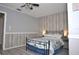 Bedroom with wood-like wall and a bed at 117 114Th N Ave # 117, St Petersburg, FL 33716