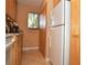 View of kitchen with white appliances and wood cabinets at 117 114Th N Ave # 117, St Petersburg, FL 33716