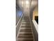 Modern stairs with wood-look laminate and neutral walls at 117 114Th N Ave # 117, St Petersburg, FL 33716