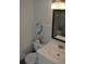 Cozy bathroom features a single sink vanity, toilet and decorative flamingo at 2690 Coral Landings Blvd # 722, Palm Harbor, FL 34684
