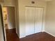 Bedroom with hardwood floors and closet with bifold doors at 2690 Coral Landings Blvd # 722, Palm Harbor, FL 34684