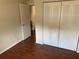 Bedroom with hardwood floors and closet with bifold doors at 2690 Coral Landings Blvd # 722, Palm Harbor, FL 34684