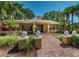 Clubhouse entrance framed by landscaped walkway and decorative orbs at 2690 Coral Landings Blvd # 722, Palm Harbor, FL 34684