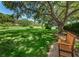 Beautiful green community space with lawn, benches, mature trees, and water views at 2690 Coral Landings Blvd # 722, Palm Harbor, FL 34684