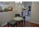 View of dining area with stools and table, which opens up to a kitchen with stainless steel appliances at 2690 Coral Landings Blvd # 722, Palm Harbor, FL 34684