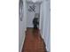Hallway with wood flooring and white trim leading to other rooms at 2690 Coral Landings Blvd # 722, Palm Harbor, FL 34684