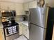 Kitchen featuring stainless steel appliances, including a refrigerator, microwave, and oven at 2690 Coral Landings Blvd # 722, Palm Harbor, FL 34684