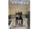 Kitchen with stainless steel microwave and oven, complemented by granite countertops and neutral-toned cabinets at 2690 Coral Landings Blvd # 722, Palm Harbor, FL 34684