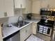 Well-lit kitchen with stainless steel appliances and white cabinets at 2690 Coral Landings Blvd # 722, Palm Harbor, FL 34684