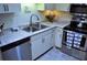 Well-lit kitchen with stainless steel appliances and white cabinets, plus modern countertops at 2690 Coral Landings Blvd # 722, Palm Harbor, FL 34684