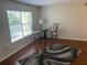 Bright living room with hardwood floors, bar stools, and a window with natural light at 2690 Coral Landings Blvd # 722, Palm Harbor, FL 34684