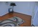 Bright living room with hardwood floors, a stylish rug, and a blue accent chair at 2690 Coral Landings Blvd # 722, Palm Harbor, FL 34684