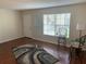 Cozy living room featuring hardwood floors, a bright window, and bar stools at 2690 Coral Landings Blvd # 722, Palm Harbor, FL 34684