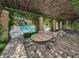 Beautiful outdoor patio with shade, ideal for entertaining, offering views of the sparkling community pool and surrounding landscape at 2690 Coral Landings Blvd # 722, Palm Harbor, FL 34684